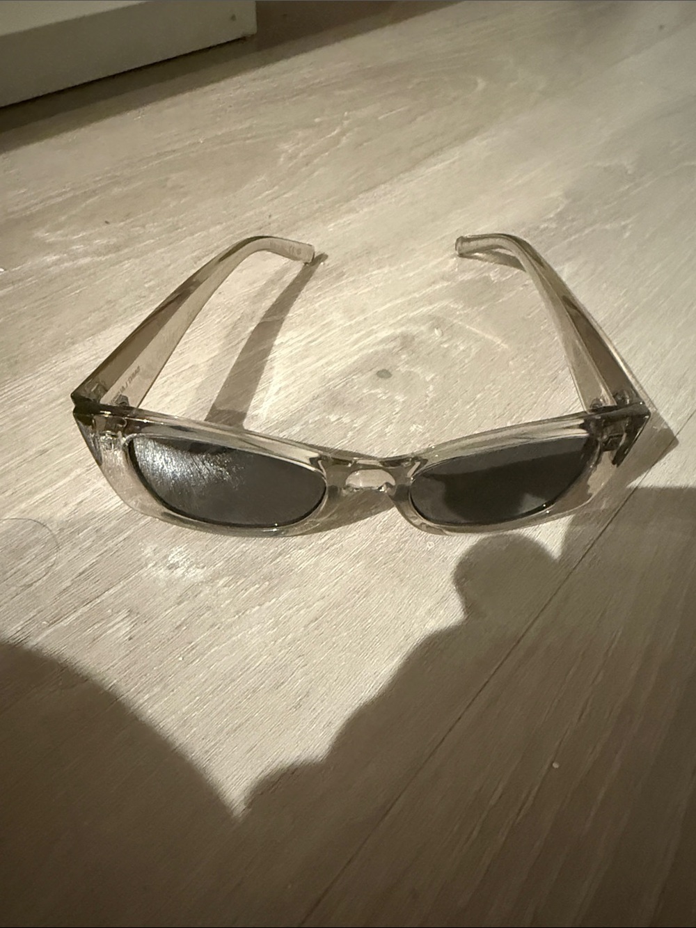 Saint Laurent Transparent Frame Sunglasses with Black Lenses